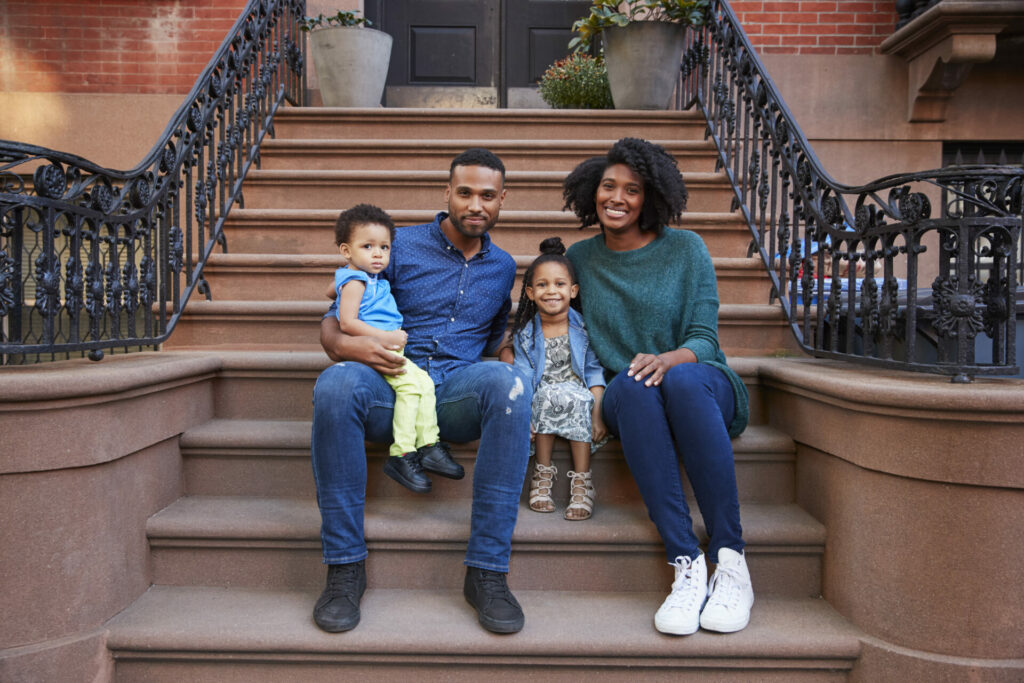 Image of couple in NYC sitting on a stoop in Brooklyn, New York